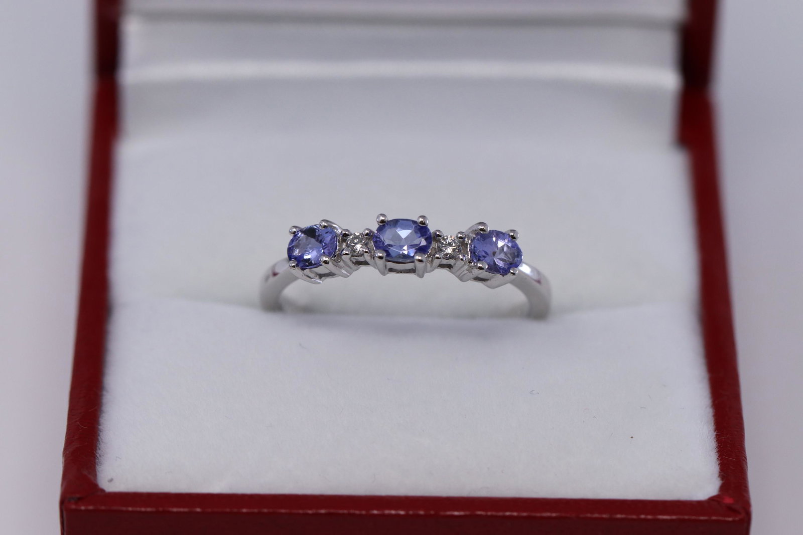 14KT White Gold Diamond|Tanzanite Ring: A ladies 14kt White Gold Diamond ring with Oval shape Tanzanite stone. There are a total of 3 Oval shape Tanzanite stone and 2 round brilliant diamonds. Ring size: 7.00. Total weight: 2.20 grams.