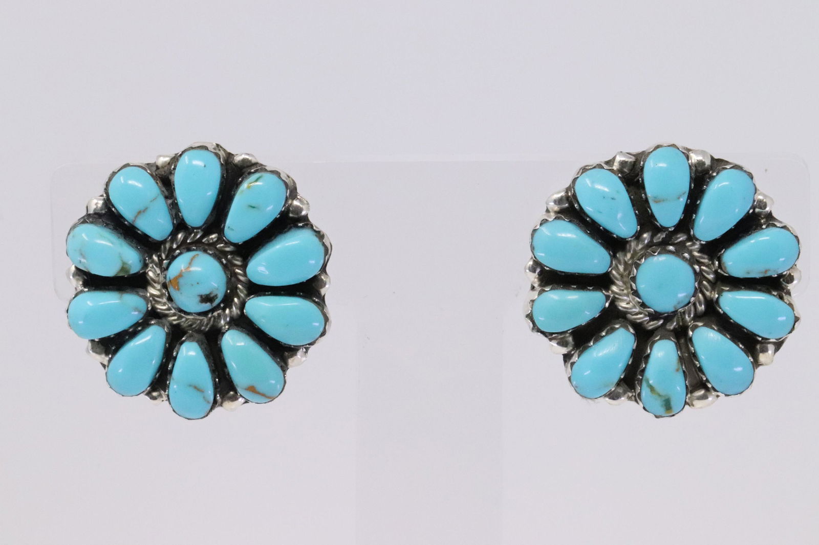 Native American Navajo Handmade Sterling Silver: This is a Native American Navajo Handmade Sterling Silver Synthetic Turquoise Cluster Earrings by Jesse Williams.