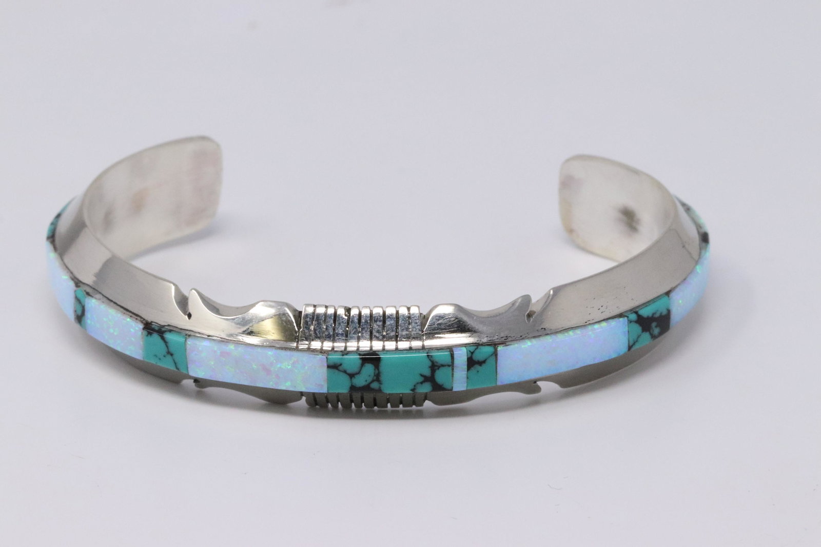 Native American Navajo Handmade Sterling Silver: This is a Native American Navajo Handmade Sterling Silver Synthetic Opal and Turquoise Inlay Bracelet by Steve Francisco.