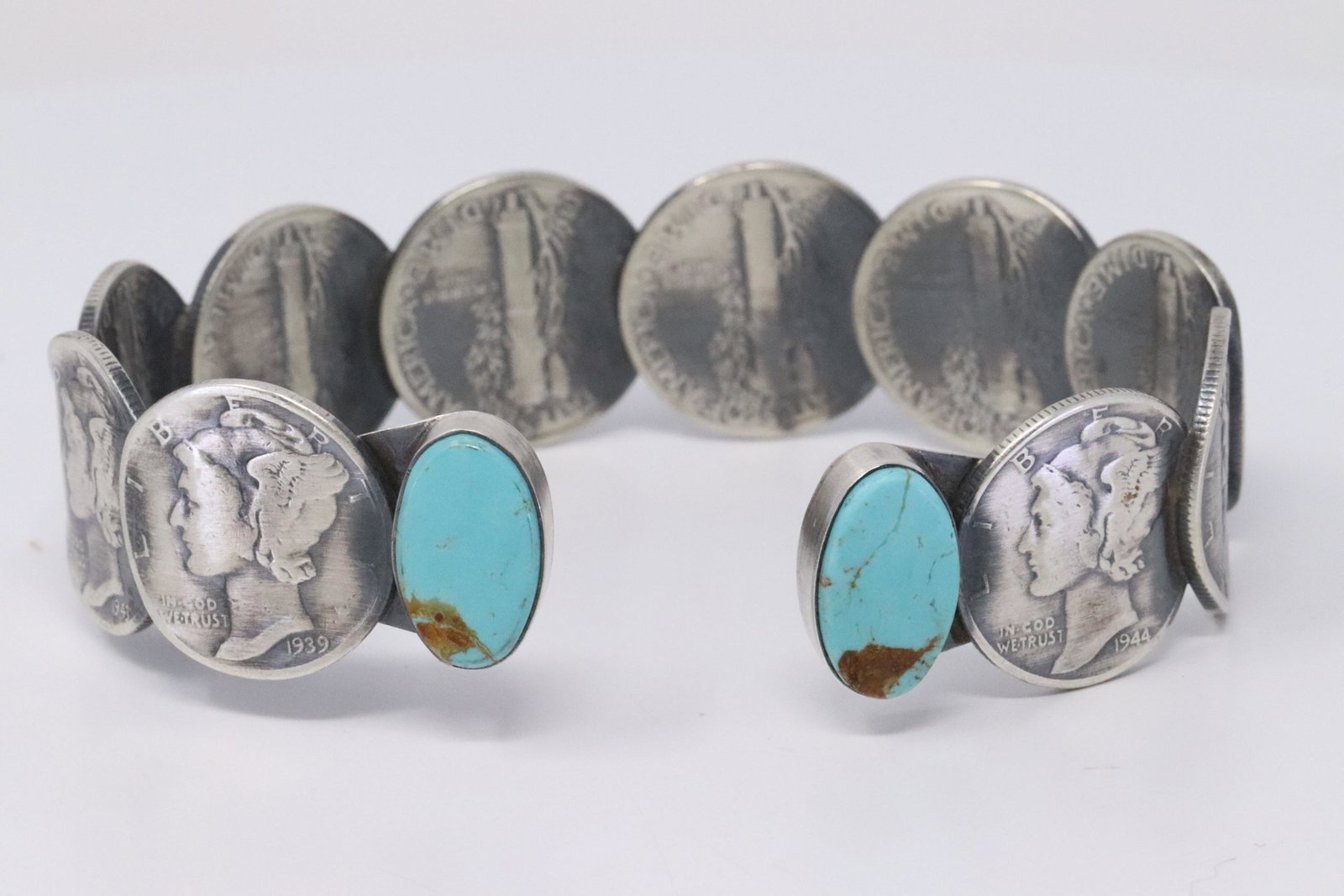 Native American Navajo Handmade Sterling Silver: This is a Native American Navajo Handmade Sterling Silver Turquoise Liberty Dime Bracelet by James McCabe.