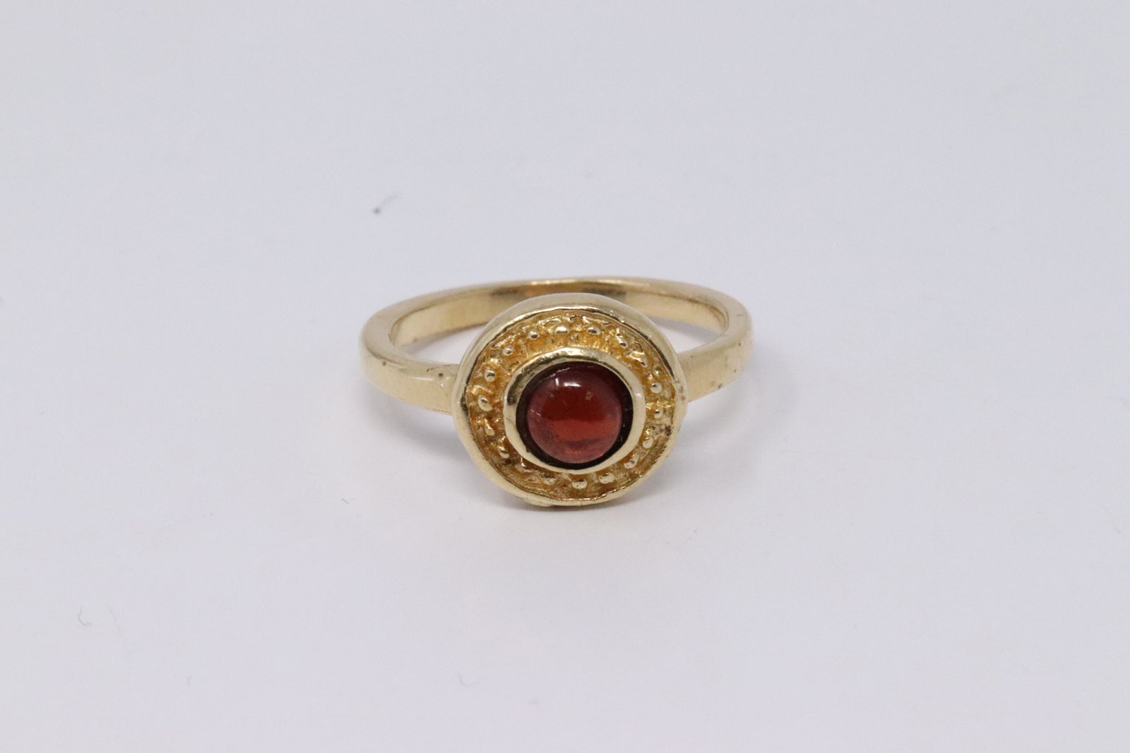 14Kt Vintage Cabochon Garnet Ring: A ladies 14kt Yellow Gold Vintage ring. Ring has a Round Cabochon Garnet stone in the center. Ring size: 5.50. Total weight 4.00 grams. SKU: AY-38FM