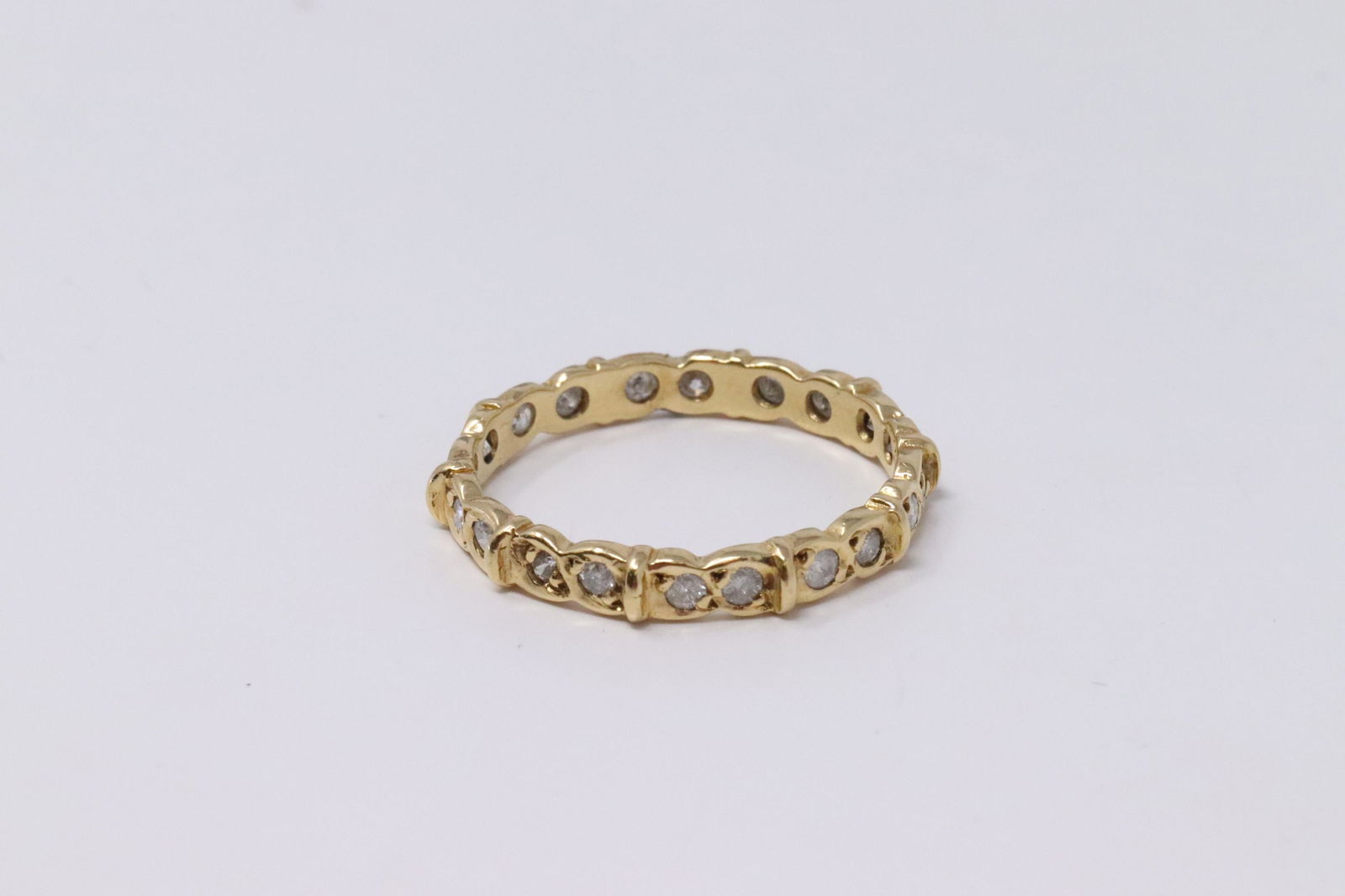 14KT Vintage Eternity Diamond Ring.: Ladies 14KT Yellow Gold Vintage Eternity Diamond Ring. Ring has a total of 20 Round Diamonds. Diamonds weight approx: 0.70cttw. Ring size: 7.50. Total weight: 2.50 grams. #AY