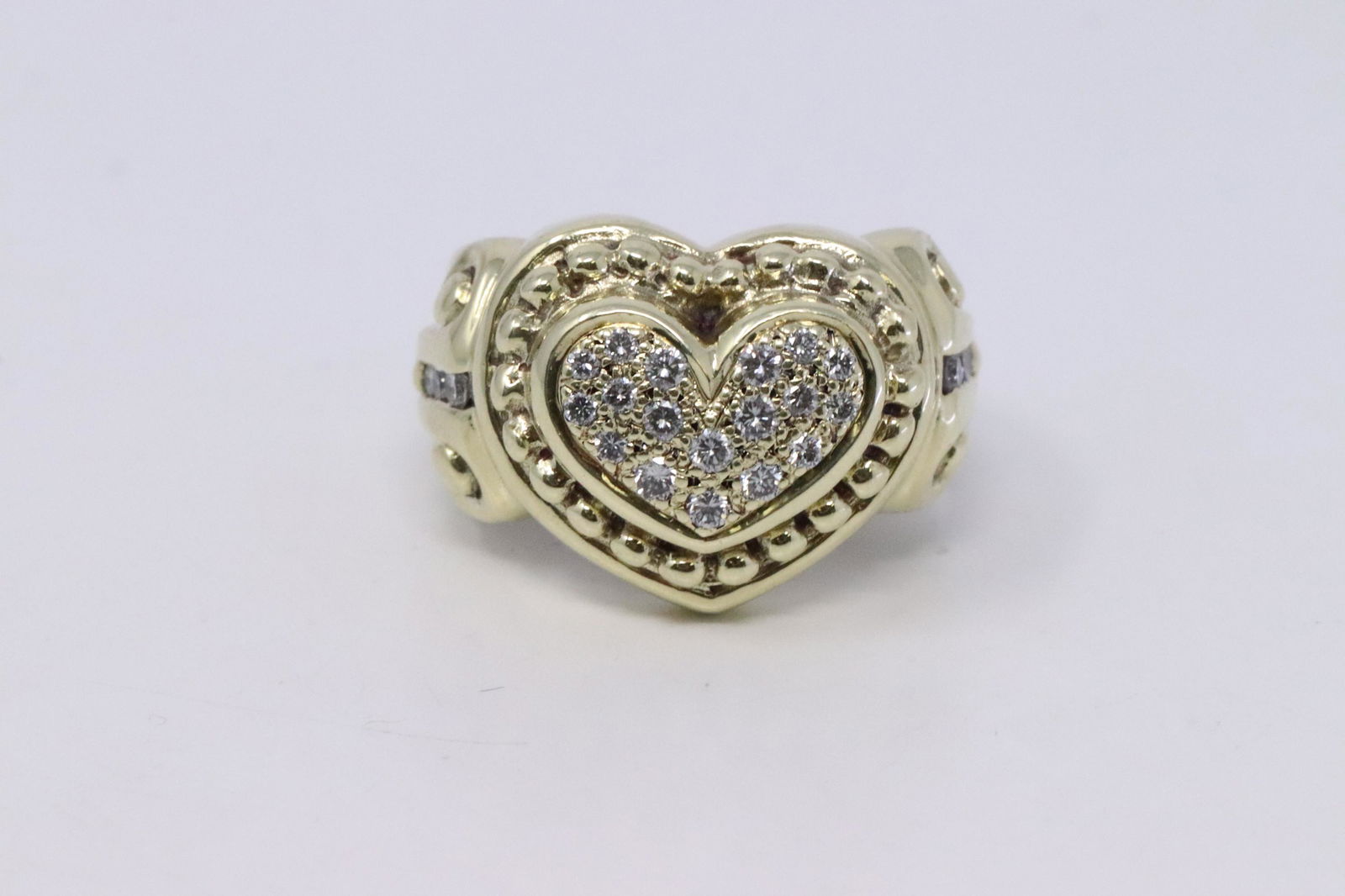 14Kt Vintage Diamond Heart Ring: A ladies 14KT Yellow Gold Vintage Diamond Heart Ring. Ring has a total of 23 round brilliant diamonds. Diamonds weight approx 0.50cttw. Ring size: 7.00. Total weight 10.00 grams.