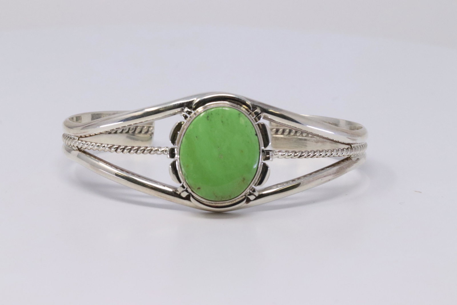 Native American Navajo Handmade Sterling Silver: This is a Native American Navajo Handmade Sterling Silver Gaspeite Bracelet by Larry Yazzie.Bracelet Measurement inside is 5.50in