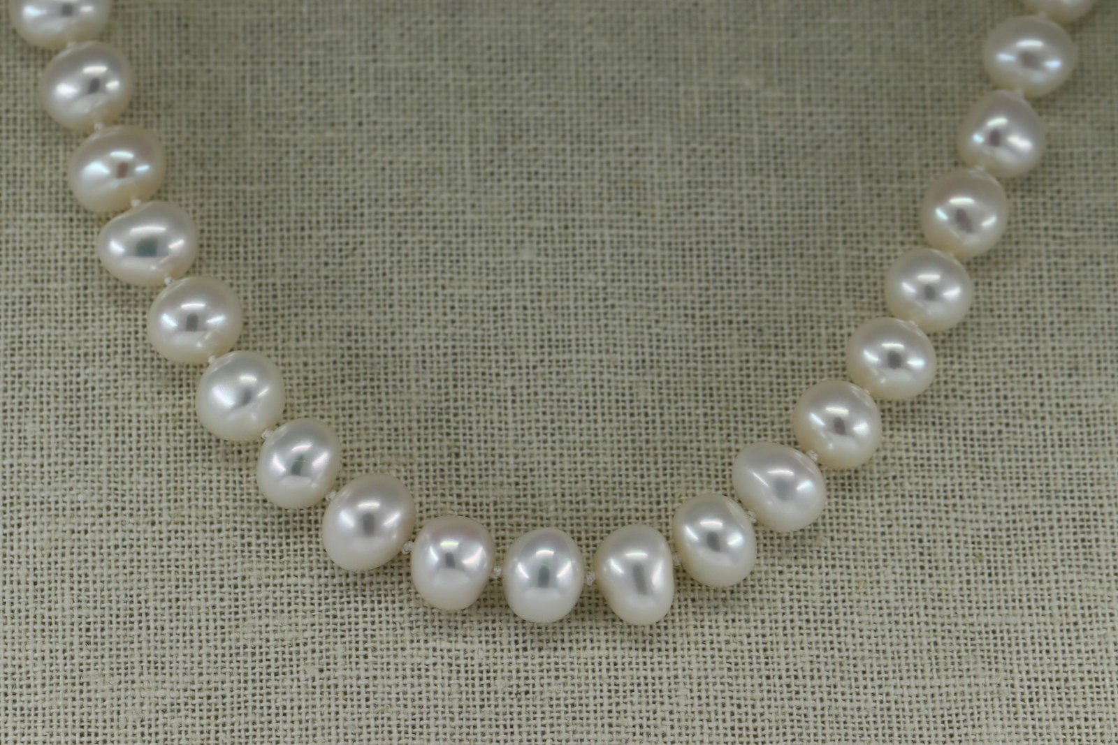 Ladies Pearl Necklace: A ladies 20.00" long white fresh water Pearls. There are a total of 45 Pearls. The clasp is .925 with a small Pearl on the center.