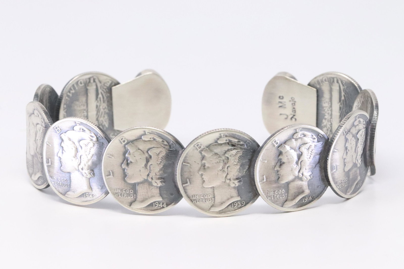 Native American Navajo Handmade Sterling Silver: This is a Native American Navajo Handmade Sterling Silver Turquoise Liberty Dime Bracelet by James McCabe.