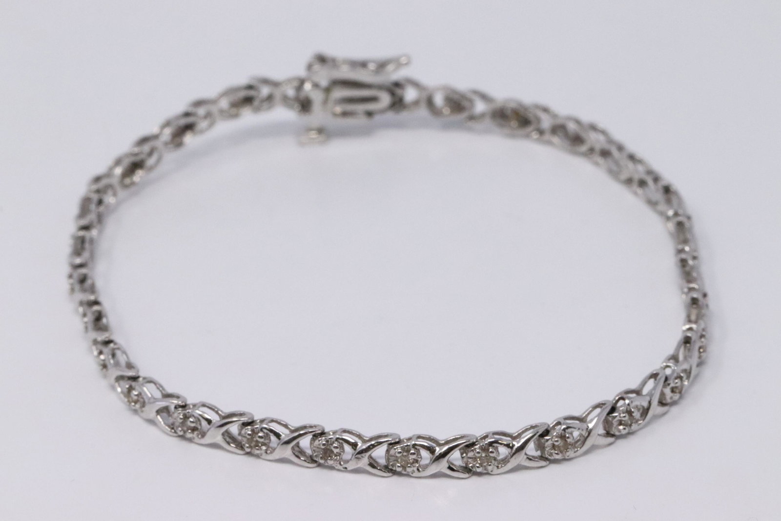 Ladies White Gold Diamond Bracelet: A ladies 10kt White Gold Diamond bracelet. Bracelet is White Gold with round diamonds. Length: 7.25in. Total weight: 4.40 grams.