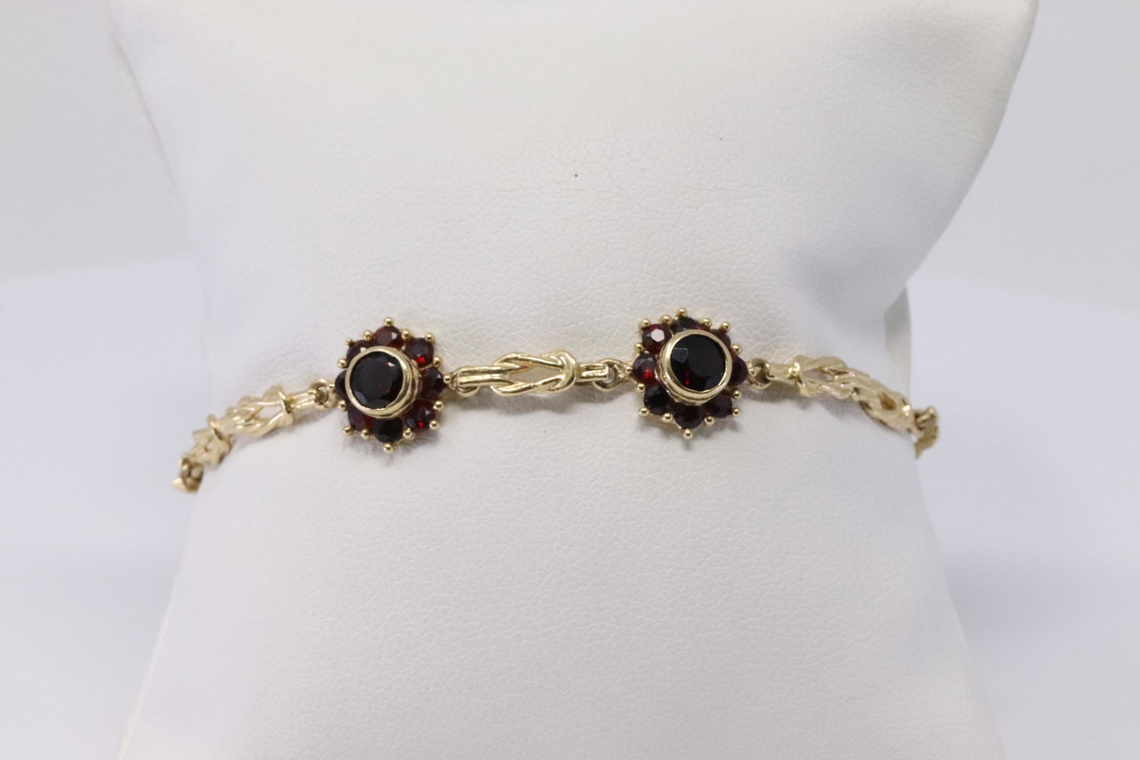 14KT Art Deco Garnet Bracelet: A ladies 14kt Art Deco Bracelet. Bracelet has settings of Garnets set in the center of the bracelet. Bracelet has a total of 18 round Garnet stones. Length: 6.00. Total weight: 7.70 grams. SKU:AYE-F8N