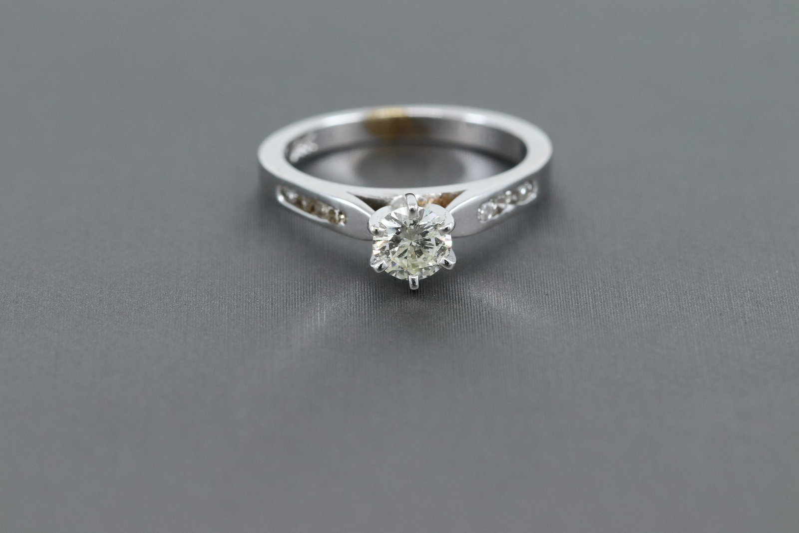14k solitaire diamond ring: 14k White gold diamond ring with center weighting approx 0.37ct., This ring weights 2.3g. Estate piece in excellent condition.