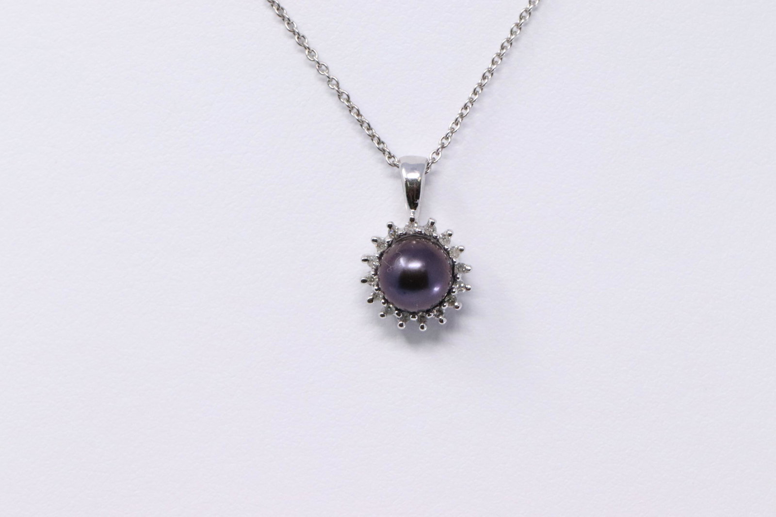 14Kt Tahitian Pearl Diamond Pendant: A ladies 14kt tahitian pearl diamond pendant. Pendant has a total of 16 round diamonds and a Pearl in the center. Pearl measures 7.10mm. Length of 14kt necklace: 16.00in. Total weight: 3.50 grams. SKU
