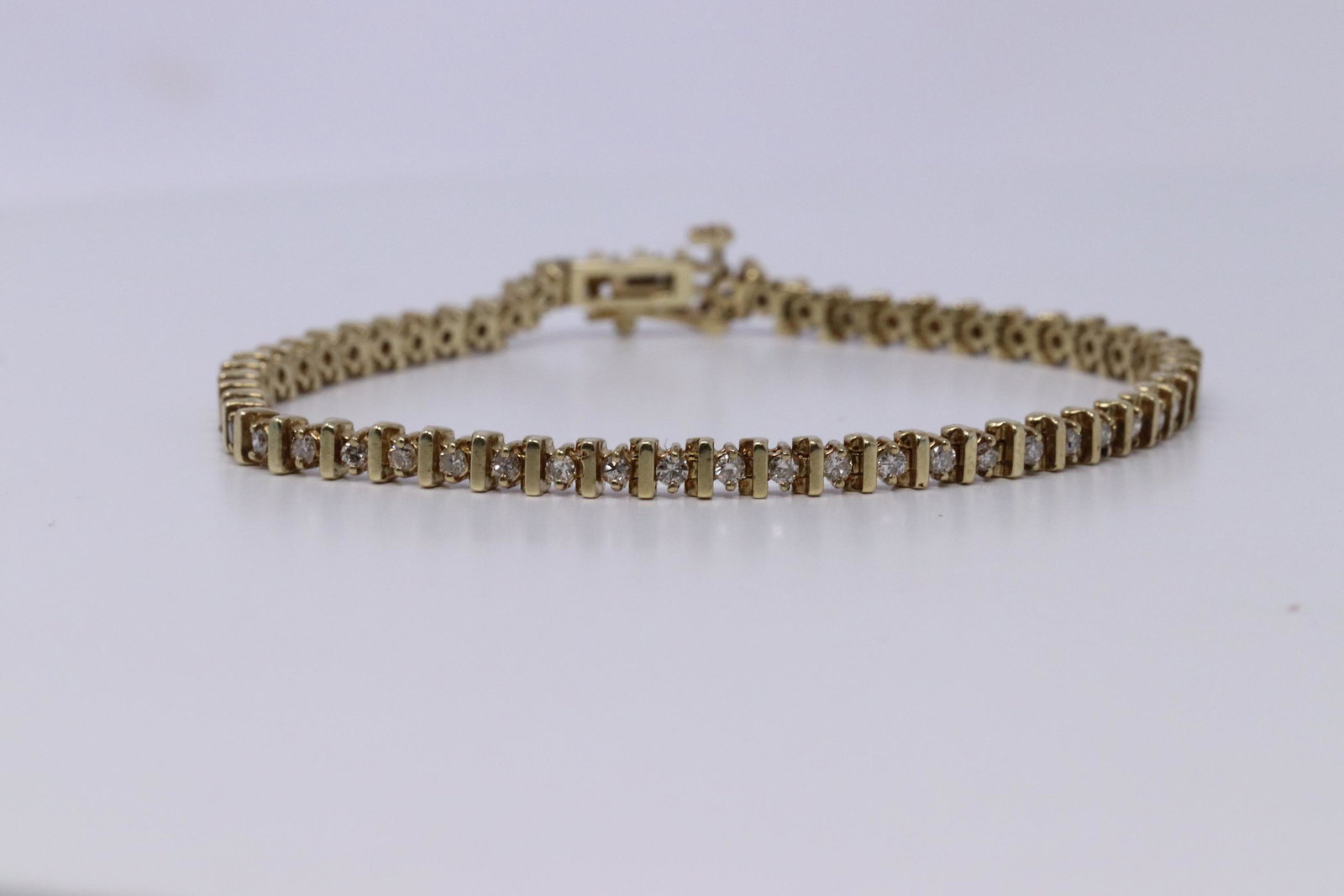 14Kt Ladies Diamond Tennis Bracelet: A ladies 14kt Yellow Gold Diamond bracelet. Bracelet has a total of 55 round brilliant diamonds. Diamonds weight approx 2.00ctw. Length of bracelet: 7.00. Total weight: 9.30 grams.