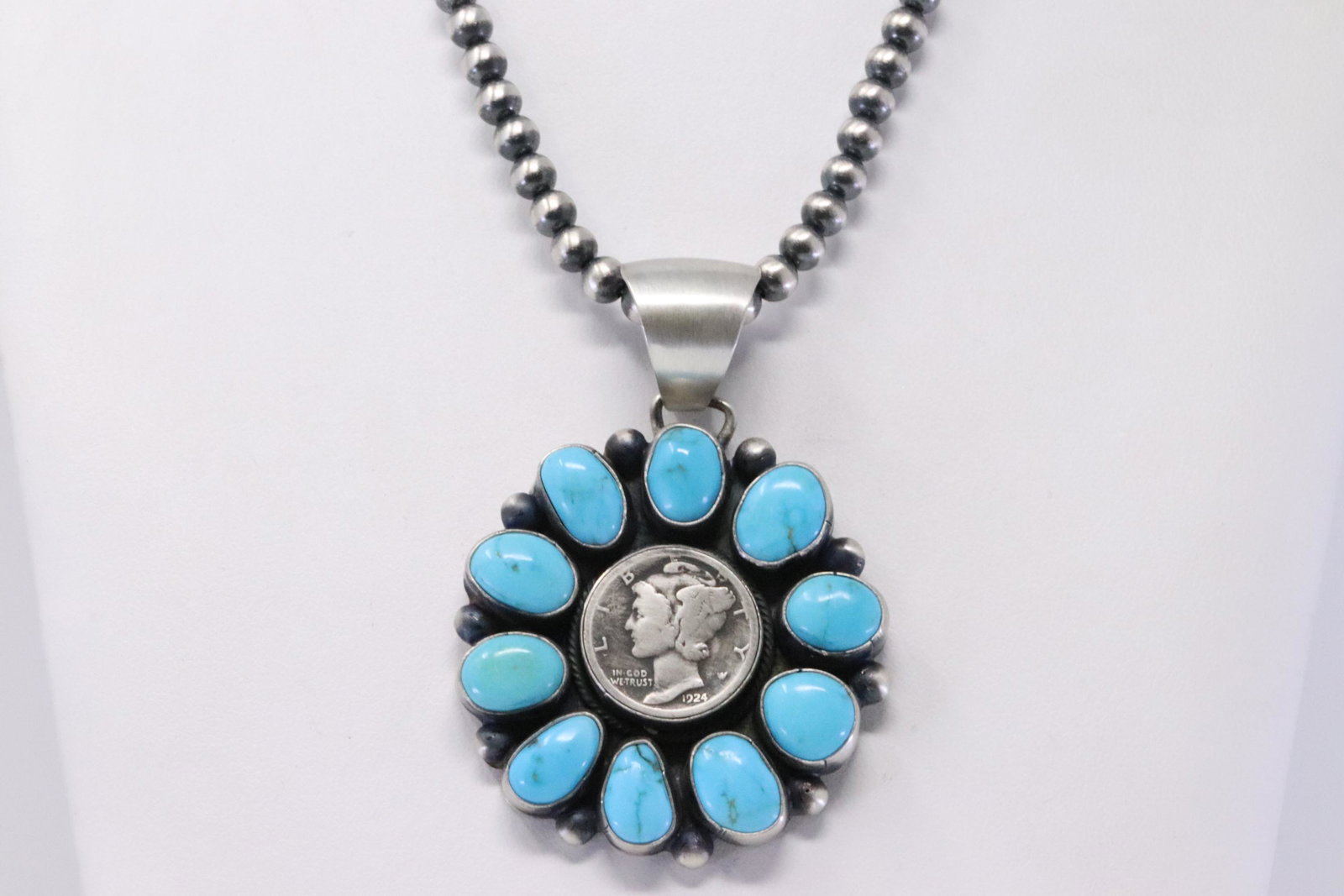 Native America Navajo Handmade Sterling Silver Dime: This is a Native America Navajo Handmade Sterling Silver Dime Kingman Turquoise Pendant & Pearl Beaded Necklace By Bobby Johnson. Necklace length: 17.00"