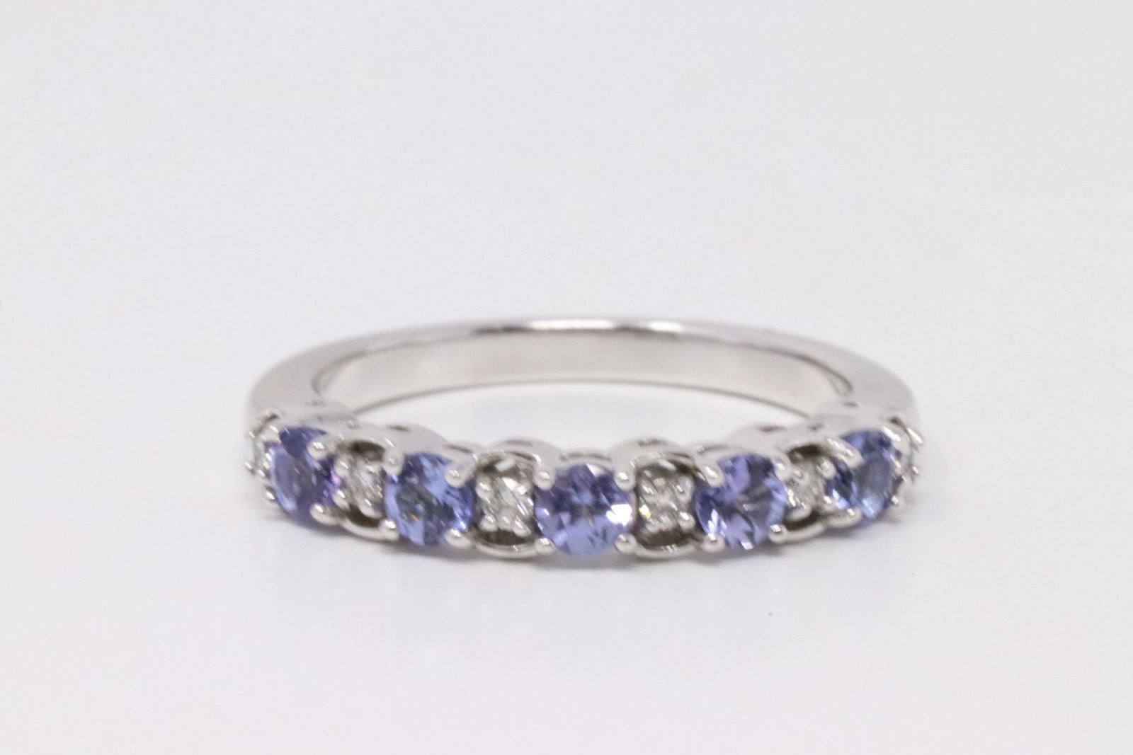 White Gold Tanzanite Diamond Ring.: Ladies White Gold Tanzanite Diamond Ring. Ring has 5 Tanzanite Stone & 6 Diamonds. Diamonds weight: 0.10ctw. Ring size: 7.00. Total weight: 3.58 Grams.