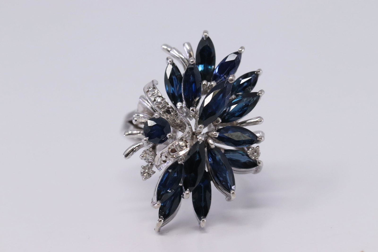 14k Diamond/Sapphire: An Amazing 14 karat white diamond ring with Marquise shapped Sapphires. The ring is in very good condition. The total weight of this beautiful ring is 13.4g and size 7.50mm.