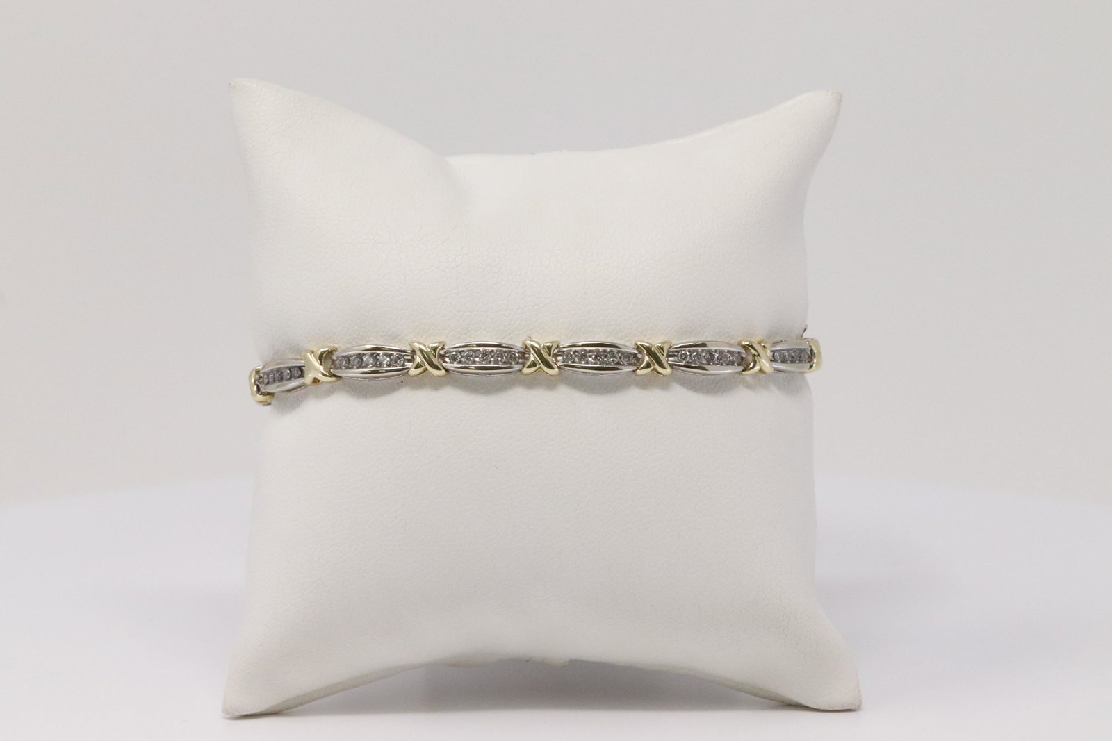 14Kt Ladies Yellow & White Gold Diamond Bracelet.: 14Kt Ladies 2 Tone Yellow & White Gold Diamond Bracelet. Bracelet has 65 round Diamonds. Diamonds weigh approx: 1.00cttw. Bracelet length: 7.50". Weight: 9.85 Grams.