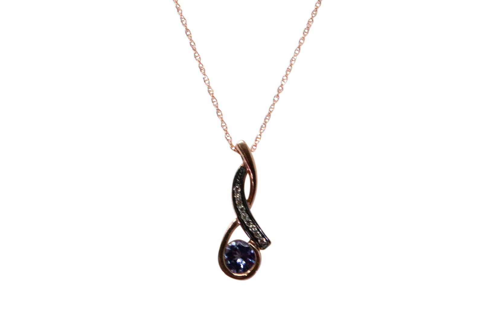 14Kt Rose Gold Tanzanite Diamond Pendant.: Ladies 14Kt Rose Gold Tanzanite Diamond Pendant. Pendant has One Purple Tanzanite With Diamonds & 14K Necklace. Necklace length: 18.00" Total weight: 2.46 Grams.