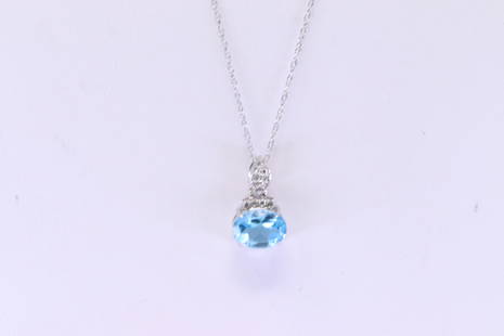 Blue Topaz & Diamond Pendant / Necklace 10Kt.: Ladies 10Kt White Gold Blue Topaz & Diamond Pendant / Necklace. Pendant has one Blue Topaz Gesmtone with 12 round Diamonds & A 10k necklace. Diamonds weight: 0.06 cttw. Necklace length: 18.00"