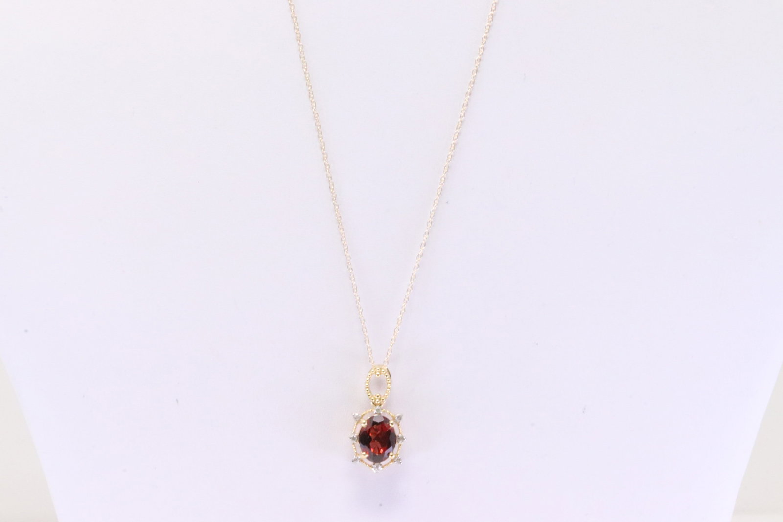 Garnet & Diamond Pendant / Necklace 10Kt.: Ladies 10Kt Yellow Gold Garnet & Diamond Pendant / Necklace. Necklace has Pendant with Oval Garnet Gems & 8 round Diamonds. Diamonds weight: 0.06ctw. Necklace length: 18.00"