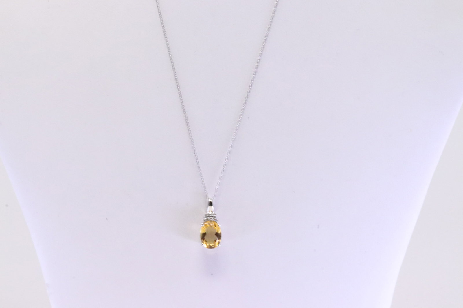 Citrine & Diamond Pendant / Necklace 10Kt.: Ladies 10Kt White Gold Citrine & Diamond Pendant / Necklace. Necklace has Pendant with Oval Citrine Gemstone & Diamonds. Diamonds weight: 0.05 ctw. Necklace length: 18.00"
