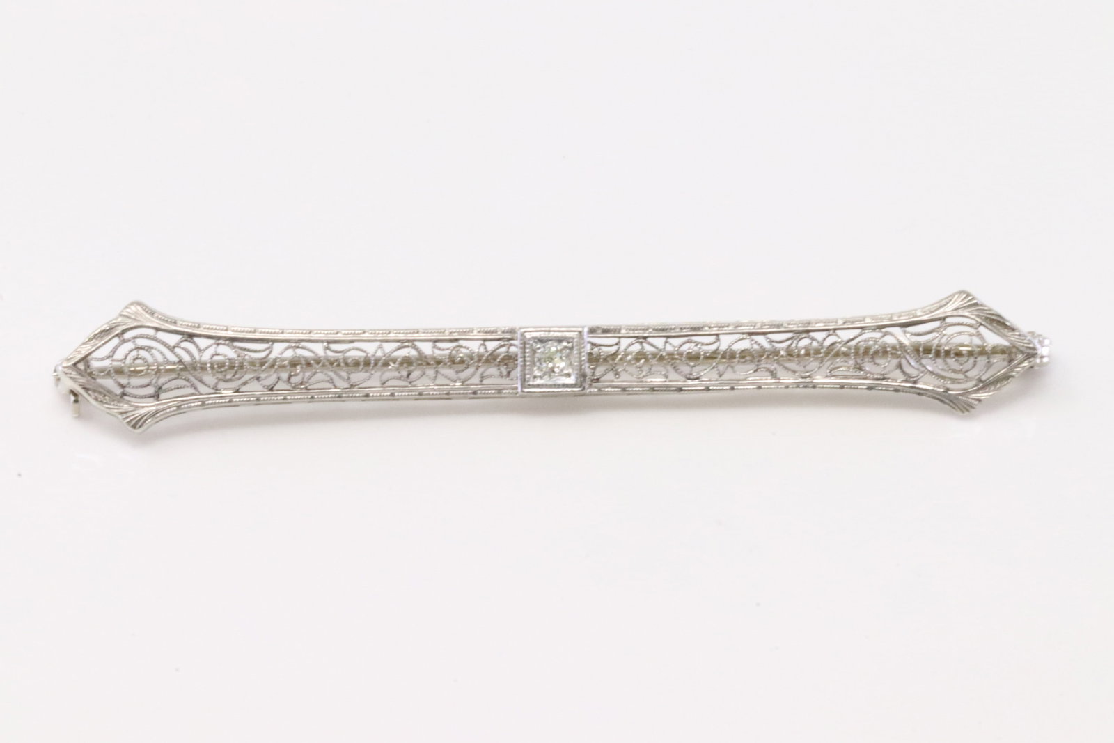 Diamond Art Deco Brooch 14Kt.: 14Kt White Gold Diamond Art Deco Brooch. Brooch has Center round Diamond. Diamond weight: 0.05ctw. Total weight: 3.70 Grams