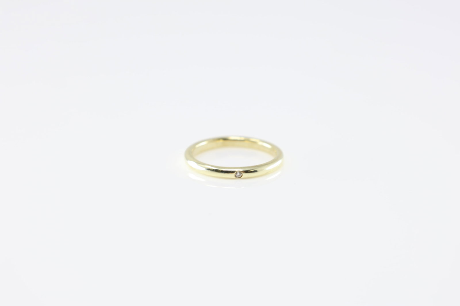 Diamond Ring 14Kt.: 14Kt Yellow Gold Diamond Ring. This classic band ring has one round diamond in the center. Ring size: 3.50.
