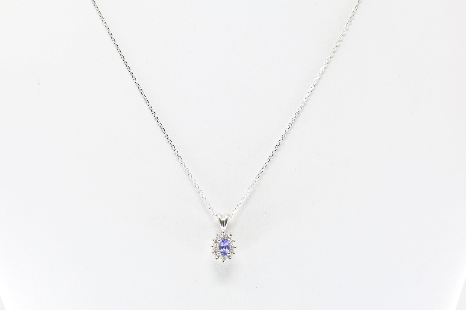 Tanzanite & Diamond Pendant / Necklace 14Kt.: 14Kt White Gold Tanzanite & Diamond Pendant / Necklace. Pendant has oval tanzanite gems with 12 round diamonds. & a 14K white chaim. Necklace length: 18.00" Total weight: 2.90 Grams.