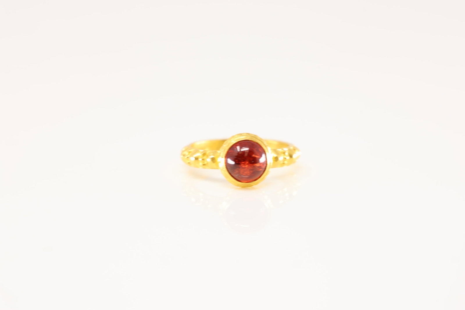 Garnet Ring 22Kt.: 22Kt Yellow Gold Garnet Ring. This ring has one round garnet gems in the center. Ring size: 6.50. Total weight: 6.60 Grams.