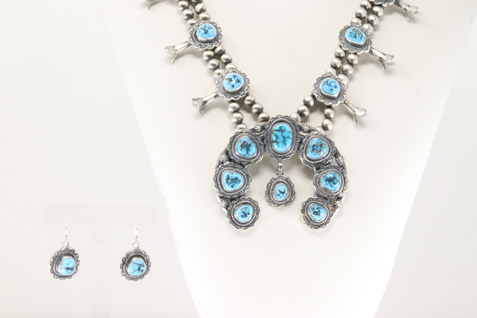 Native America Navajo Sterling Silver Kingman Turquoise Squash Blossom Necklace & Earring's Set By: This is a Native America Navajo Sterling Silver Kingman Turquoise Squash Blossom Necklace & Earring's Set By Thomas Francisco. Necklace length: 28.00" Total weight: 180.50 Grams.