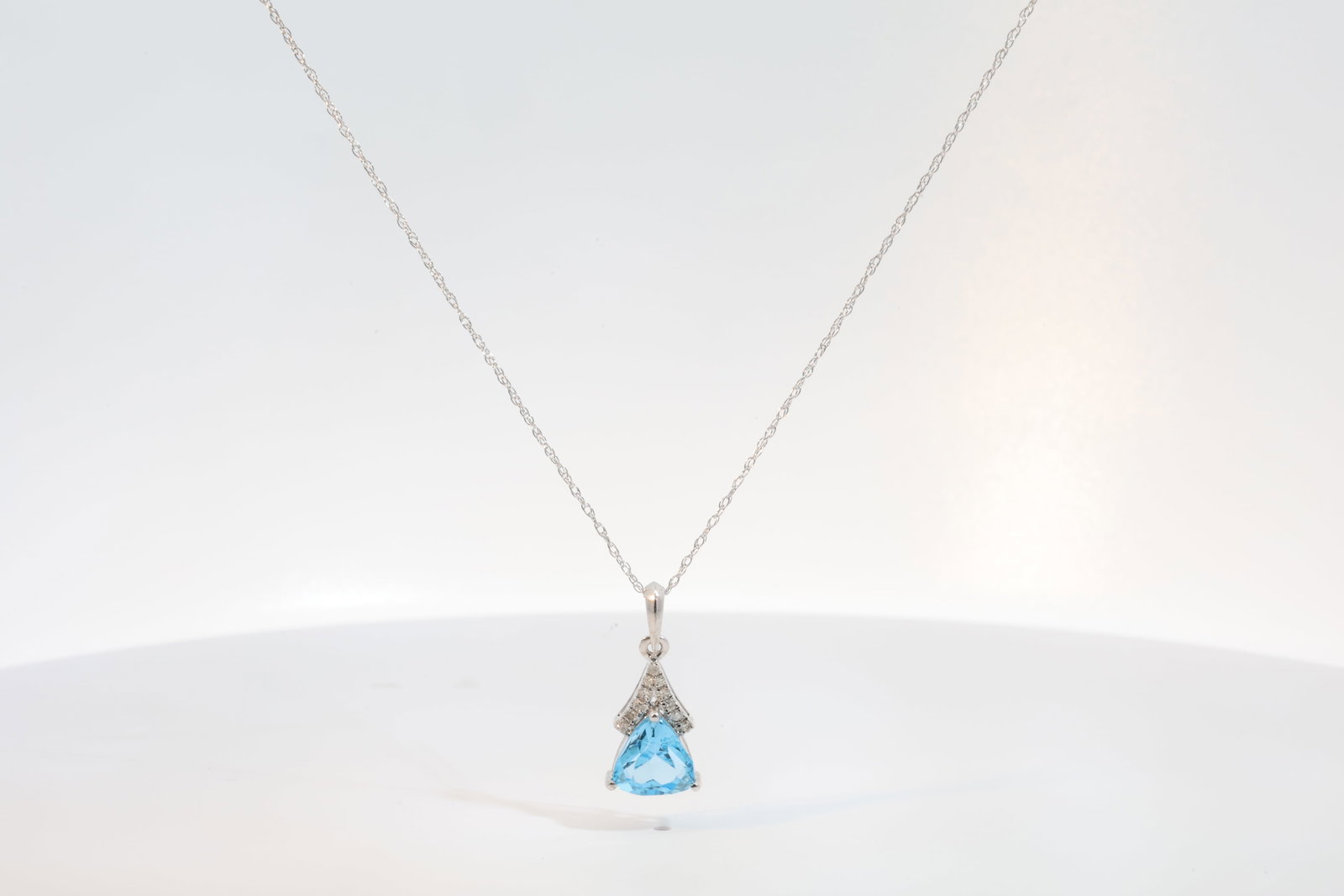 Blue Topaz & Diamond Pendant / Necklace 10Kt.: Ladies 10Kt White Gold Blue Topaz Pendant / Necklace. Necklace has Pendant with one Blue Topaz Gems & round Diamonds. Diamonds weight: 0.06ct. Necklace length: 18.00"