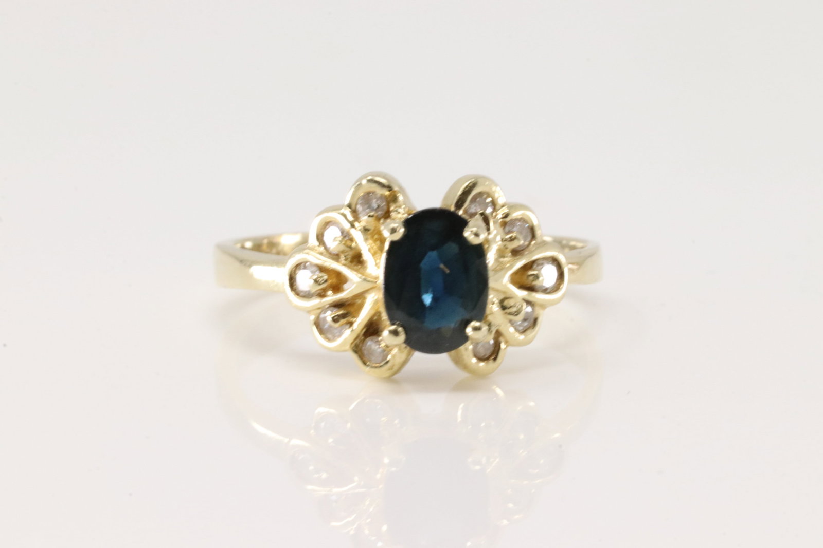 Sapphire & Diamond Ring 14Kt.: Ladies 14Kt Yellow Gold Sapphire & Diamond Ring. This charming ring has oval sapphire surrender by 10 sparkling diamonds. Ring size: 7.50. Total weight: 3.40 Grams.