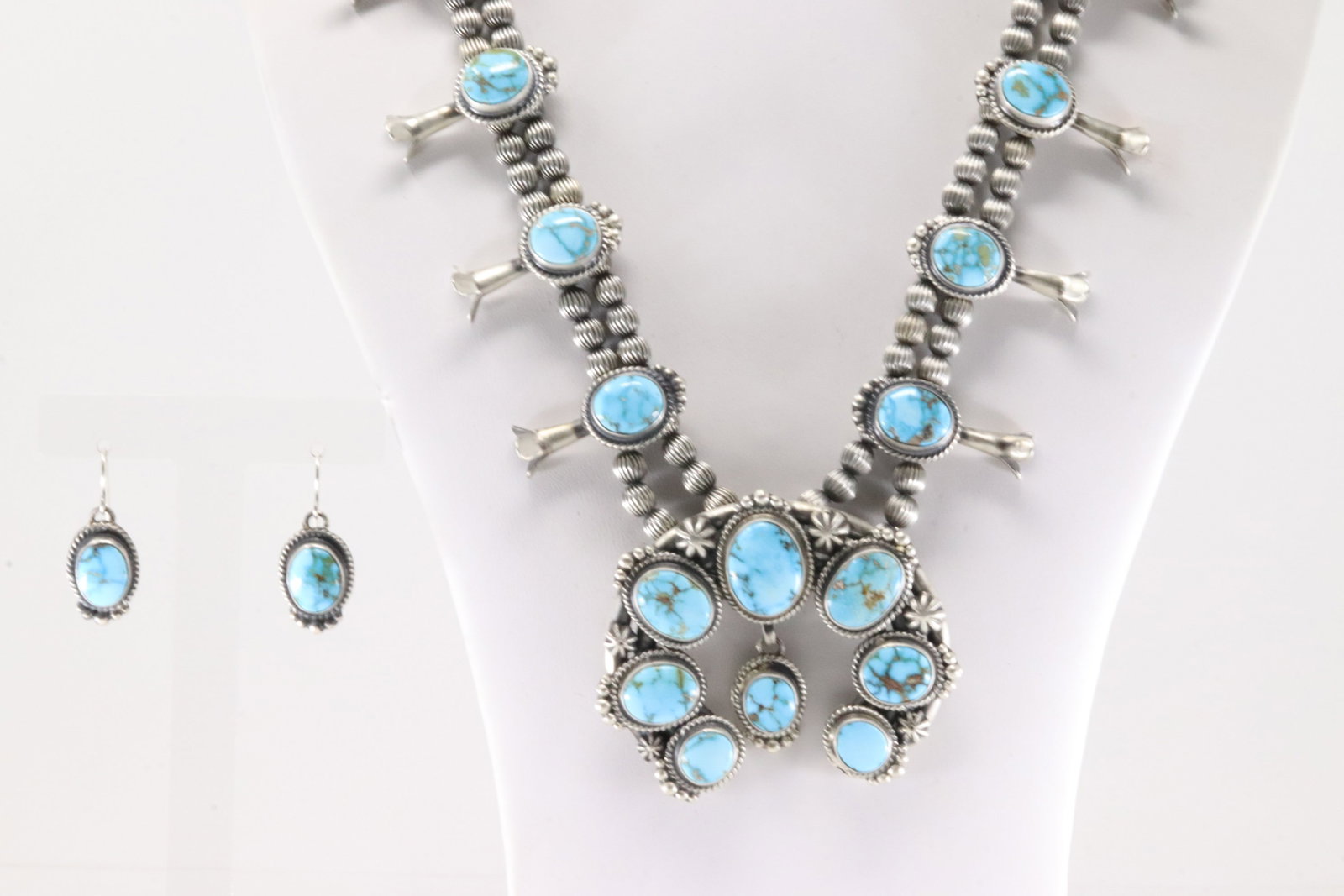 Native America Navajo Sterling Silver Kingman Turquoise Squash Blossom Necklace & Earring's Set By: This is a Native America Navajo Sterling Silver Kingman Turquoise Squash Blossom Necklace & Earring's Set By Thomas Francisco. Necklace length: 24.00" Total weight: 161.50 Grams.