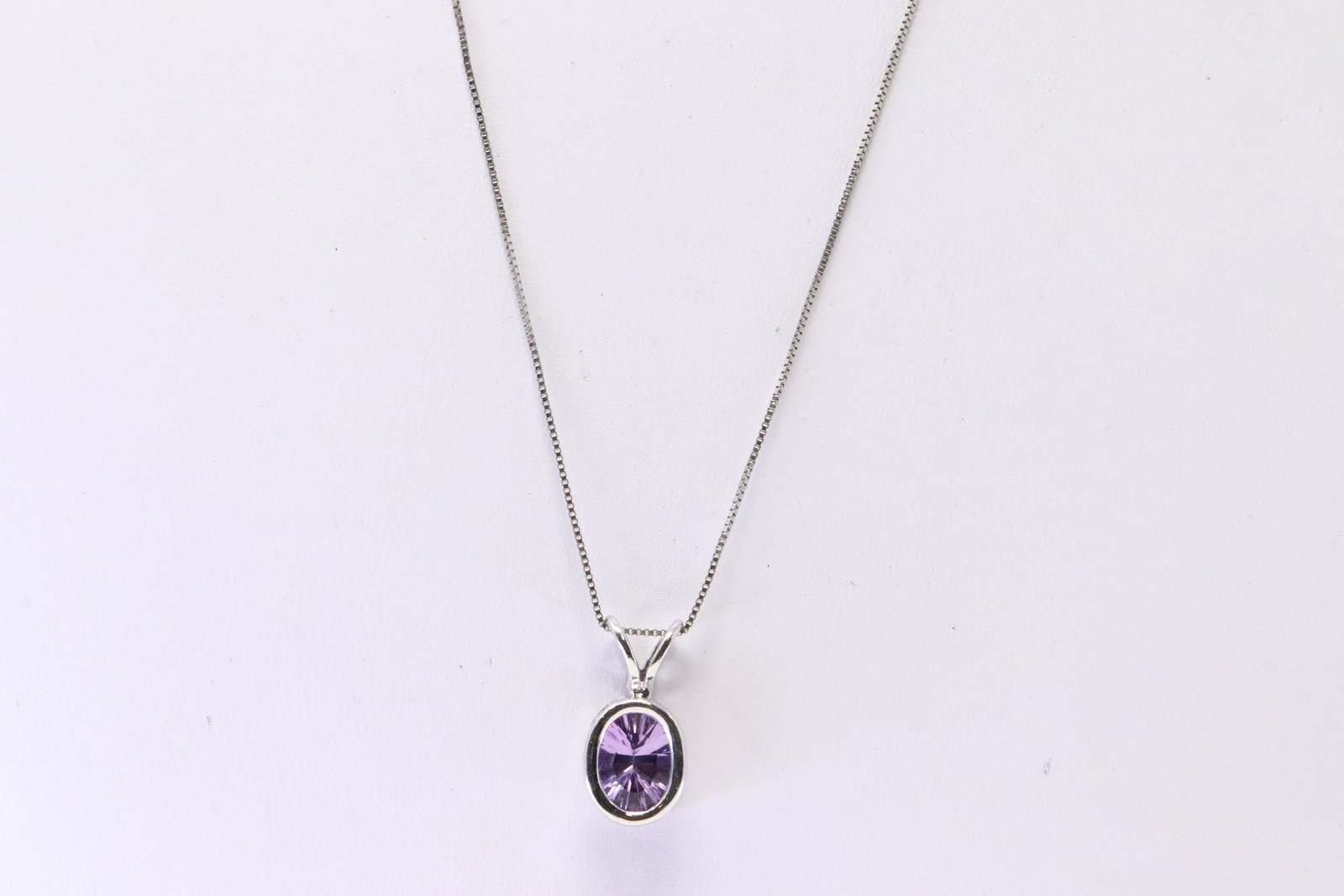 Amethyst Pendant 14Kt.: 14Kt White Gold Amethyst Pendant. Pendant has 1 Oval Amethyst Gemstone with A 14Kt Necklace. Necklace length: 18.00" Total weight: 2.40 Grams.