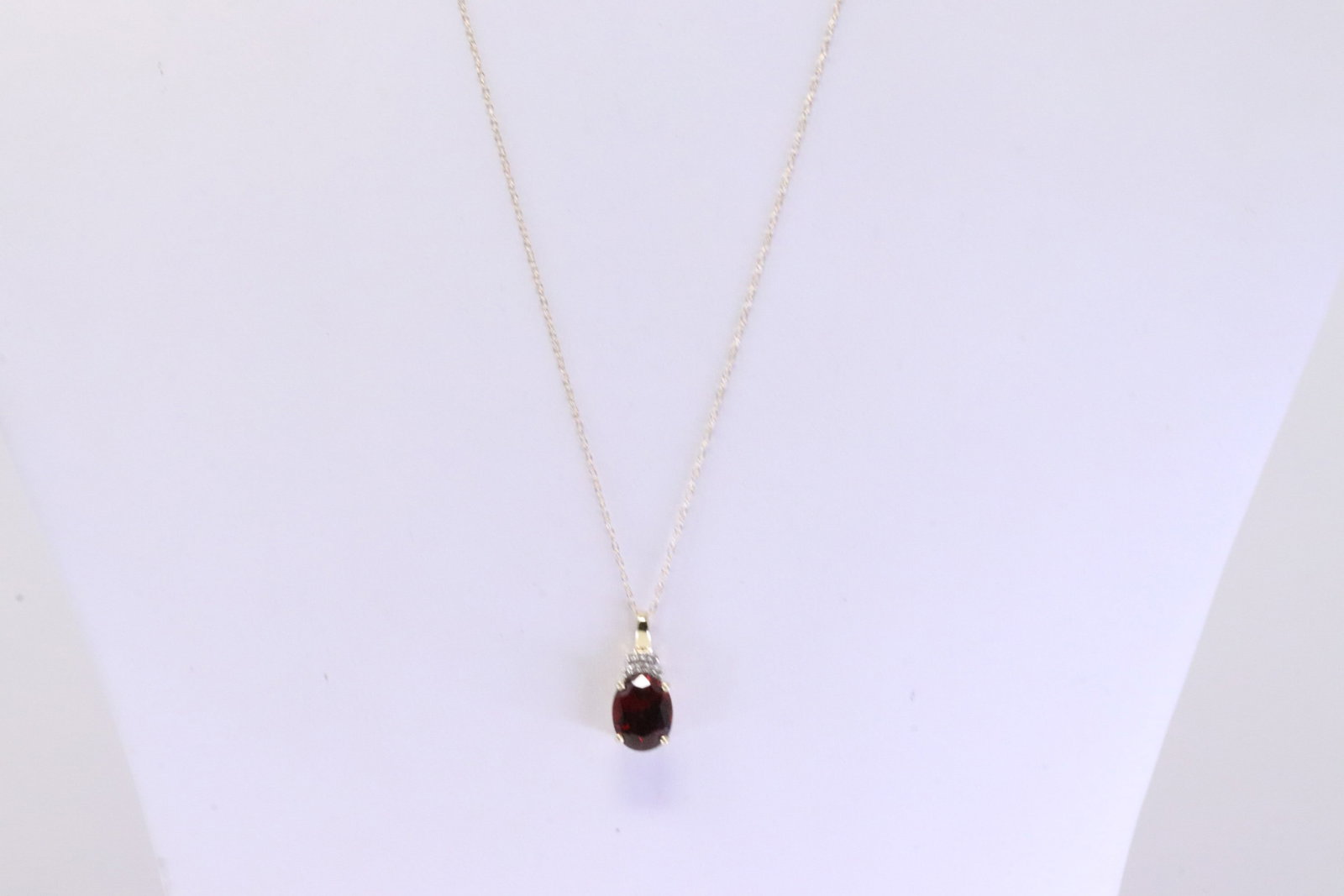 Garnet & Diamond Pendant / Necklace 10Kt.: Ladies 10Kt Yellow Gold Garnet & Diamond Pendant / Necklace. Necklace has Pendant with Oval Garnet & Diamonds. Diamonds weight: 0.05 ctw. Necklace length: 18.00"