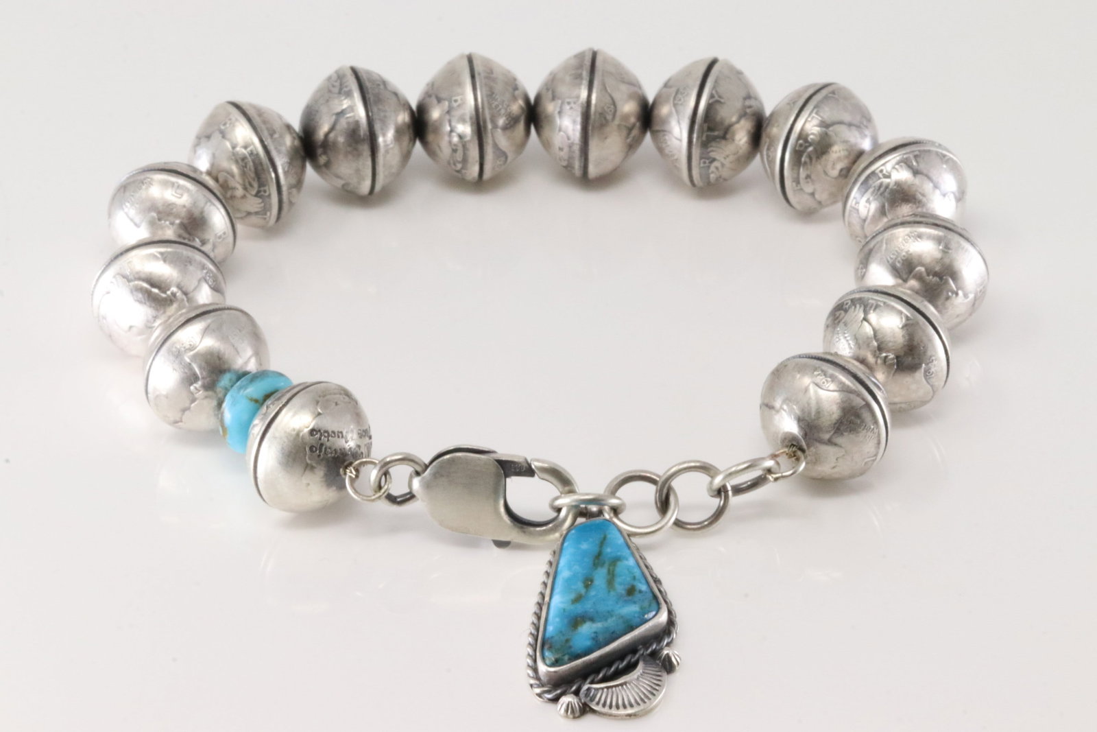 Native America Navajo Sterling Silver Kingman Turquoise Liberty Dime Bracelet Link By James McCabe.: This is a Native America Navajo Sterling Silver Kingman Turquoise Liberty Dime Bracelet Link By James McCabe. Bracelet length: 9.00" Adjustable. Total weight: 76.80 Grams.