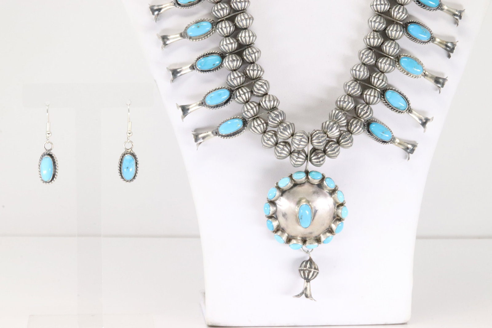 Native America Navajo Sterling Silver Kingman Turquoise Squash Blossom Necklace & Earring's Set By: This is a Native America Navajo Sterling Silver Kingman Turquoise Squash Blossom Necklace & Earring's Set By Nathanial Kirli. Necklace length: 20.00" Total weight: 93.30 Grams.