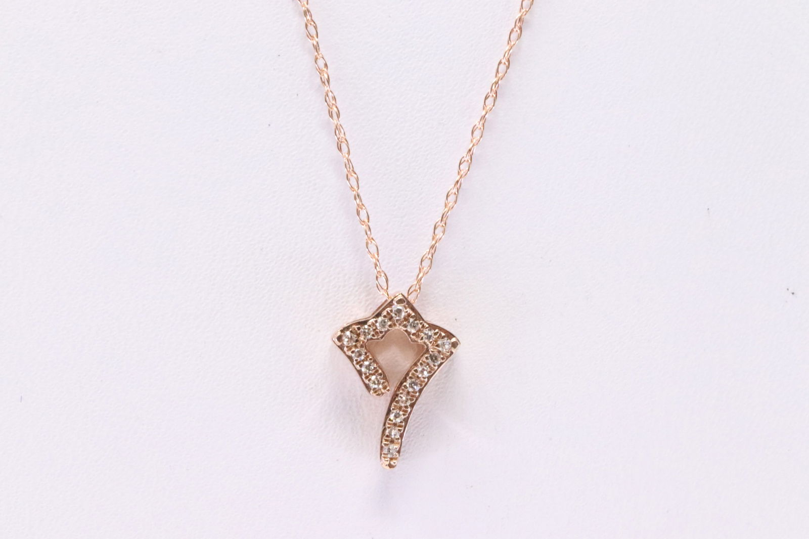 Rose Gold Diamond Pendant.: Ladies Rose Gold Diamond Pendant. Pendant has 17 round Diamond with a Necklace. Diamonds weight: 0.07ctw. Necklace length: 18.00"