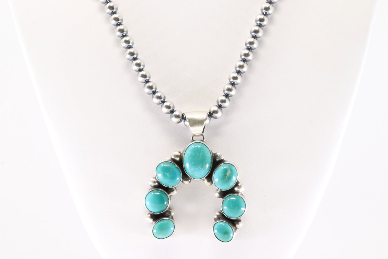 Native America Navajo Sterling Silver Kingman Naja Pendant By Augustine Largo. With None Navajo: This is a Native America Navajo Sterling Silver Kingman Naja Pendant By Augustine Largo. With None Navajo Pearl Beaded Sterling Silver Machine Made Necklace. Necklace length: 20.00"