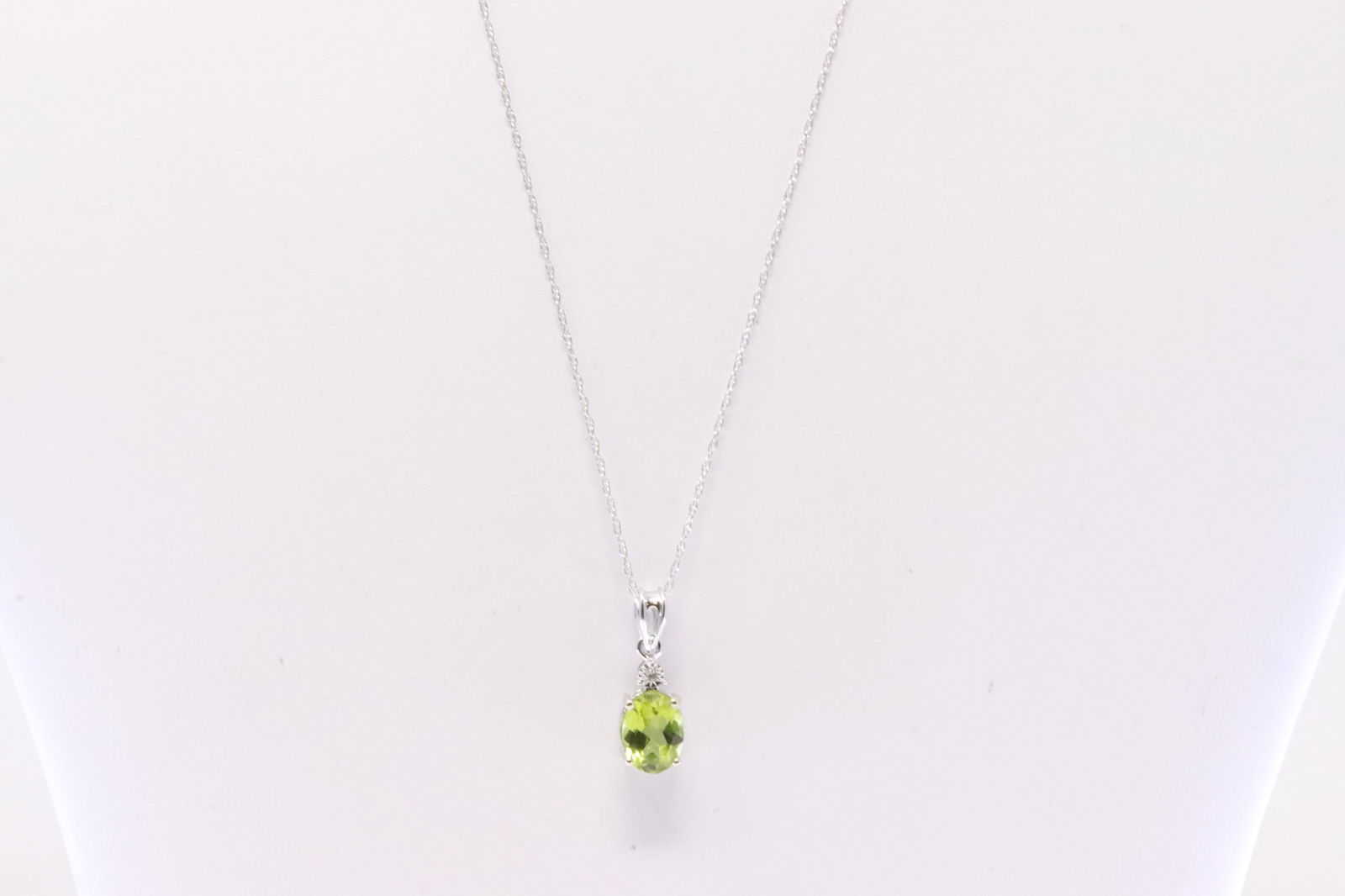 Peridot & Diamond Pendant / Necklace 10Kt.: Ladies 10Kt White Gold Peridot & Diamond Pendant / Necklace. Necklace has one Oval Green Peridot with round 18.00" Diamond. Necklace length: 18.00"