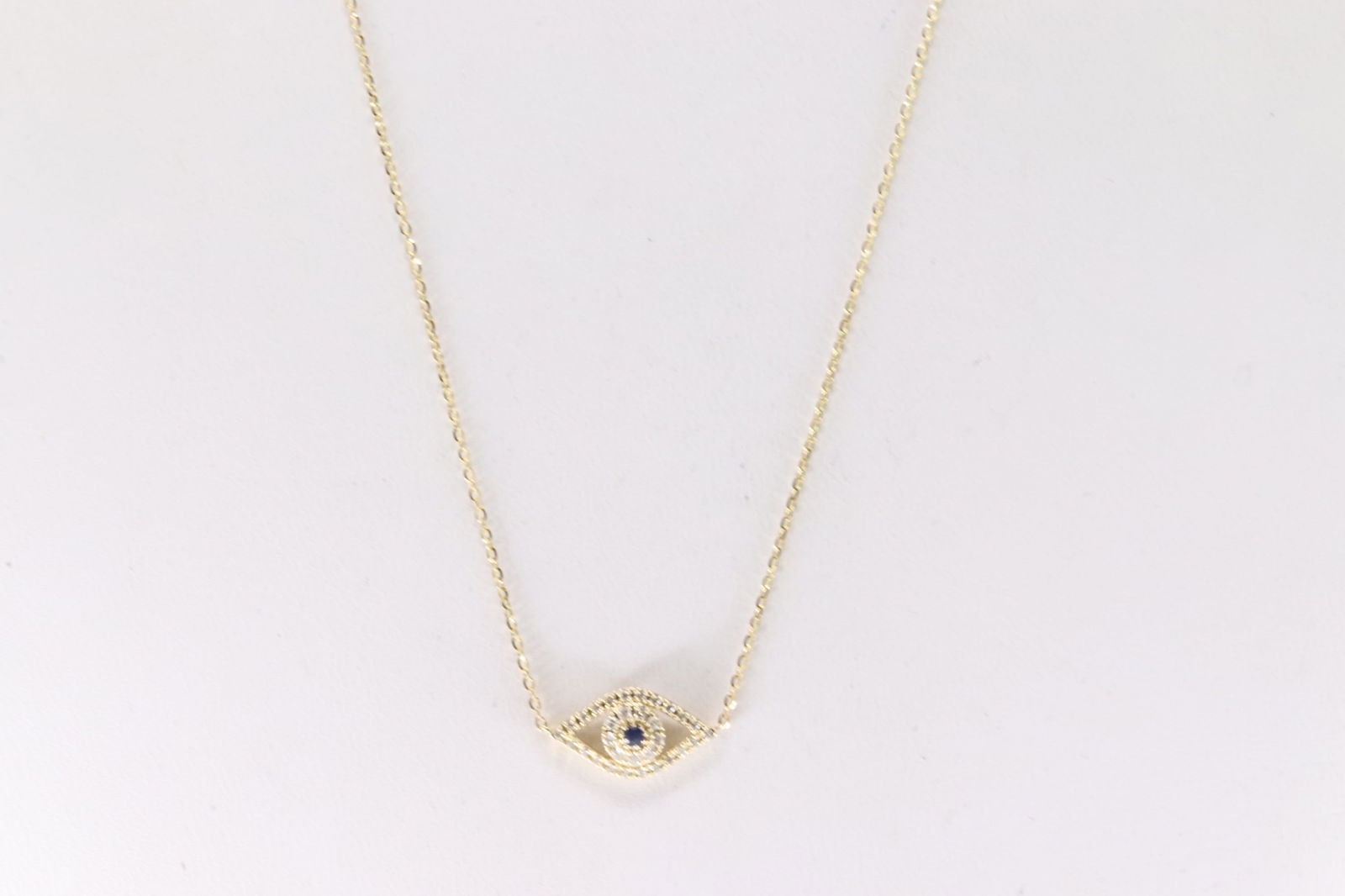 Sapphire & Diamond Eye Evil Pendant / Necklace 14Kt.: 14Kt Yellow Gold Sapphire & Diamond Eye Evil / Necklace. This pendant has eye evil design with one sapphire / sparkling diamonds and a 14k necklace. Diamonds weight approx: 0.13ctw. Necklace length: