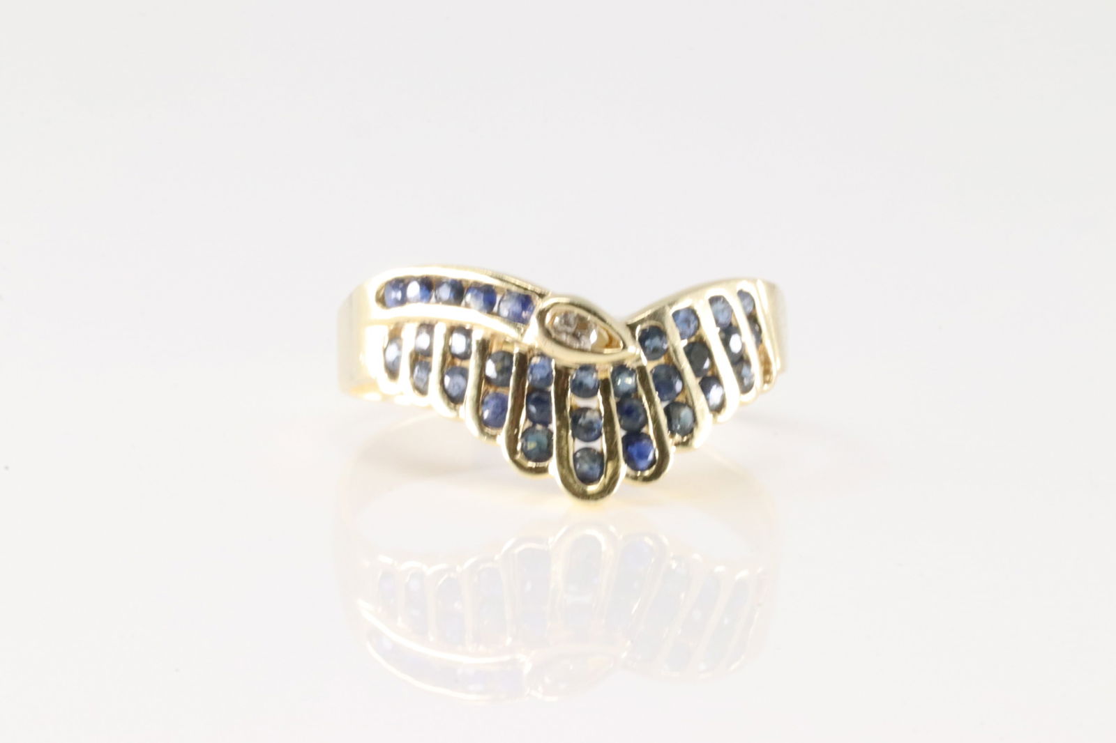 Sapphire & Diamond Ring 14Kt.: Ladies 14Kt Yellow Gold Sapphire & Diamond Ring. This ring has an unique design with 32 round sapphires with one diamond. Sapphires weight approx; Ring size: 9.00. Total weight: 3.20 Grams.