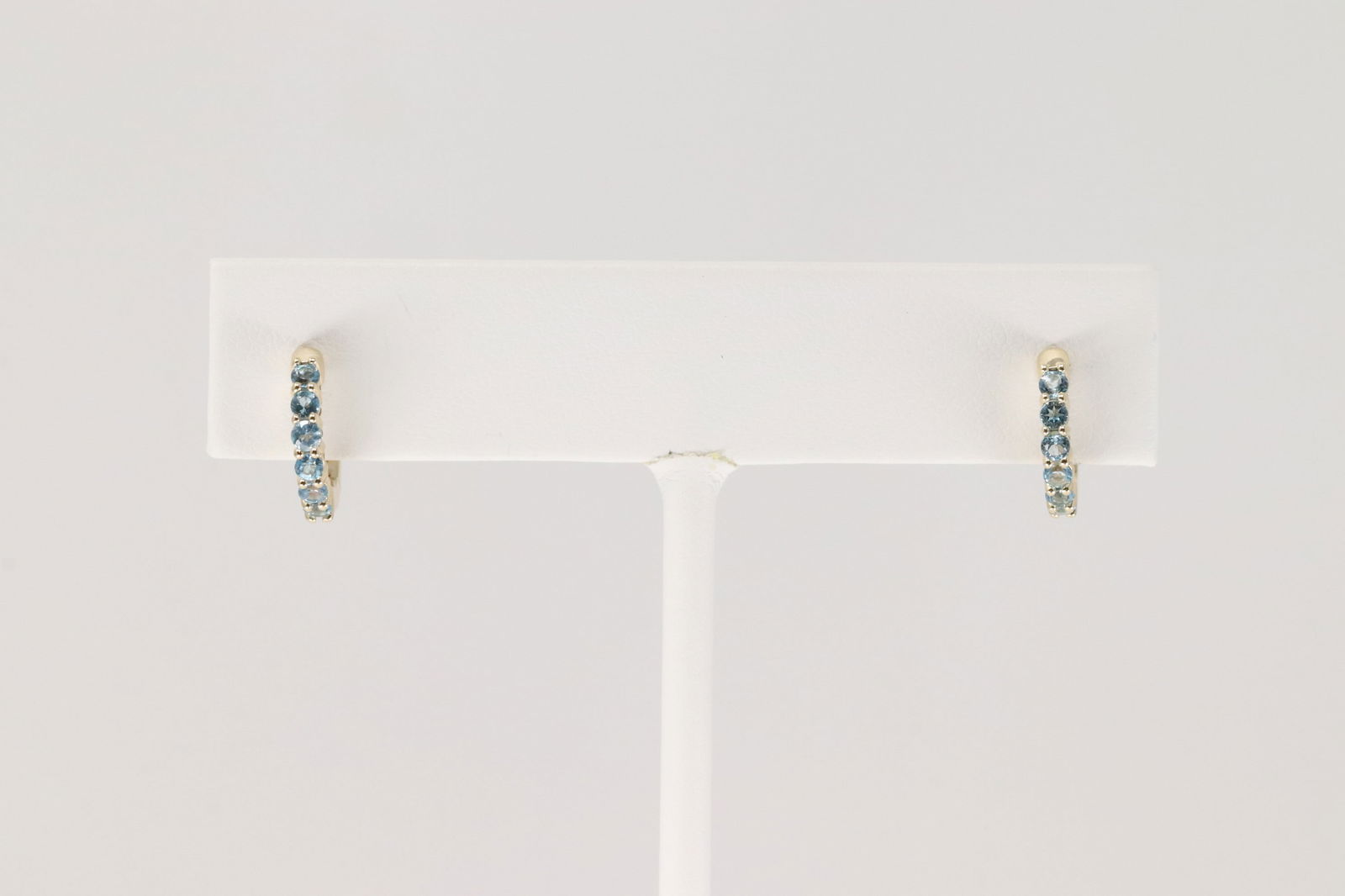 Blue Topaz Hoop Earring 10Kt.: Ladies 10Kt Yellow Gold Blue Topaz Hoop Earring. This Charming Hoop Earring has Blue Topaz Gemstone.