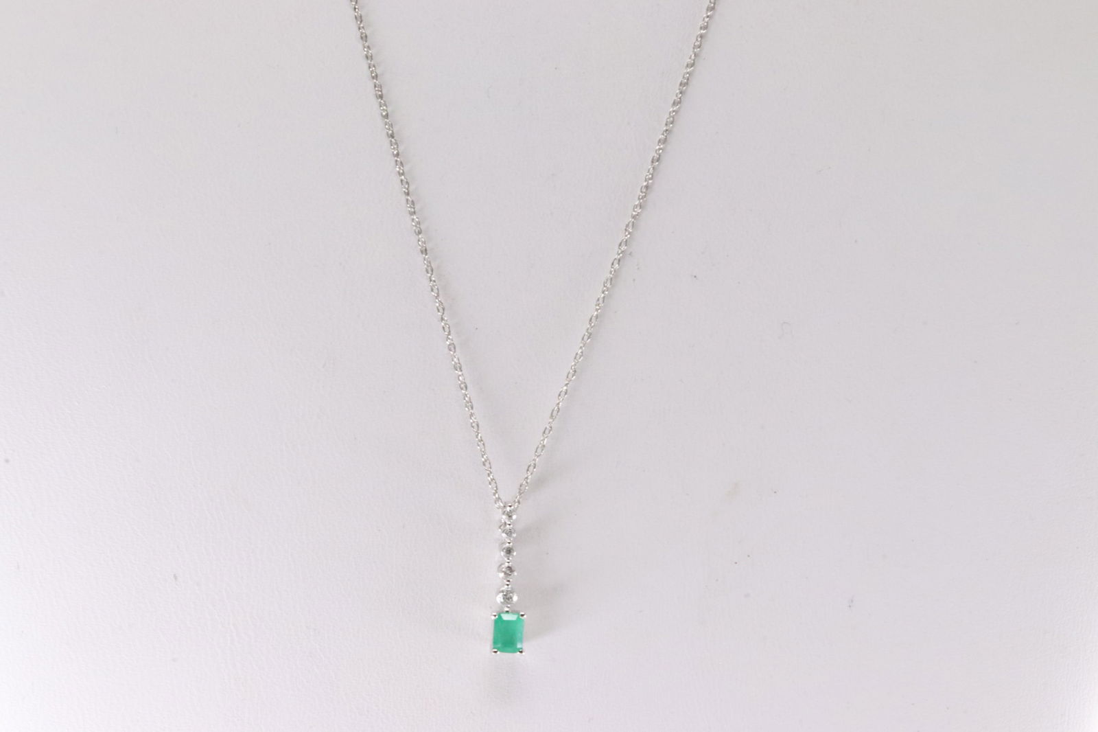 Emerald & Diamond Necklace 14Kt.: Ladies 14Kt White Gold Emerald & Diamond Necklace. Necklace has An Charm with Green Emerald & Round Diamonds. Diamonds weight: 0.07ctw. Emerald weight: 0.22ct. Necklace length: 18.00"