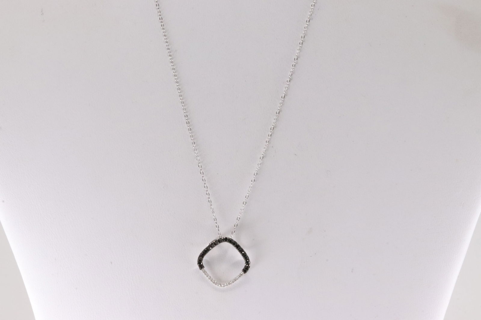 Multi-Color Diamond Necklace 14Kt.: 14Kt White Gold Multi-Color Diamond Necklace. This Necklace has A Charm with 36 Sparkling Diamonds Black & White. Diamonds weight: 0.18ctw. Necklace length: 18.00"