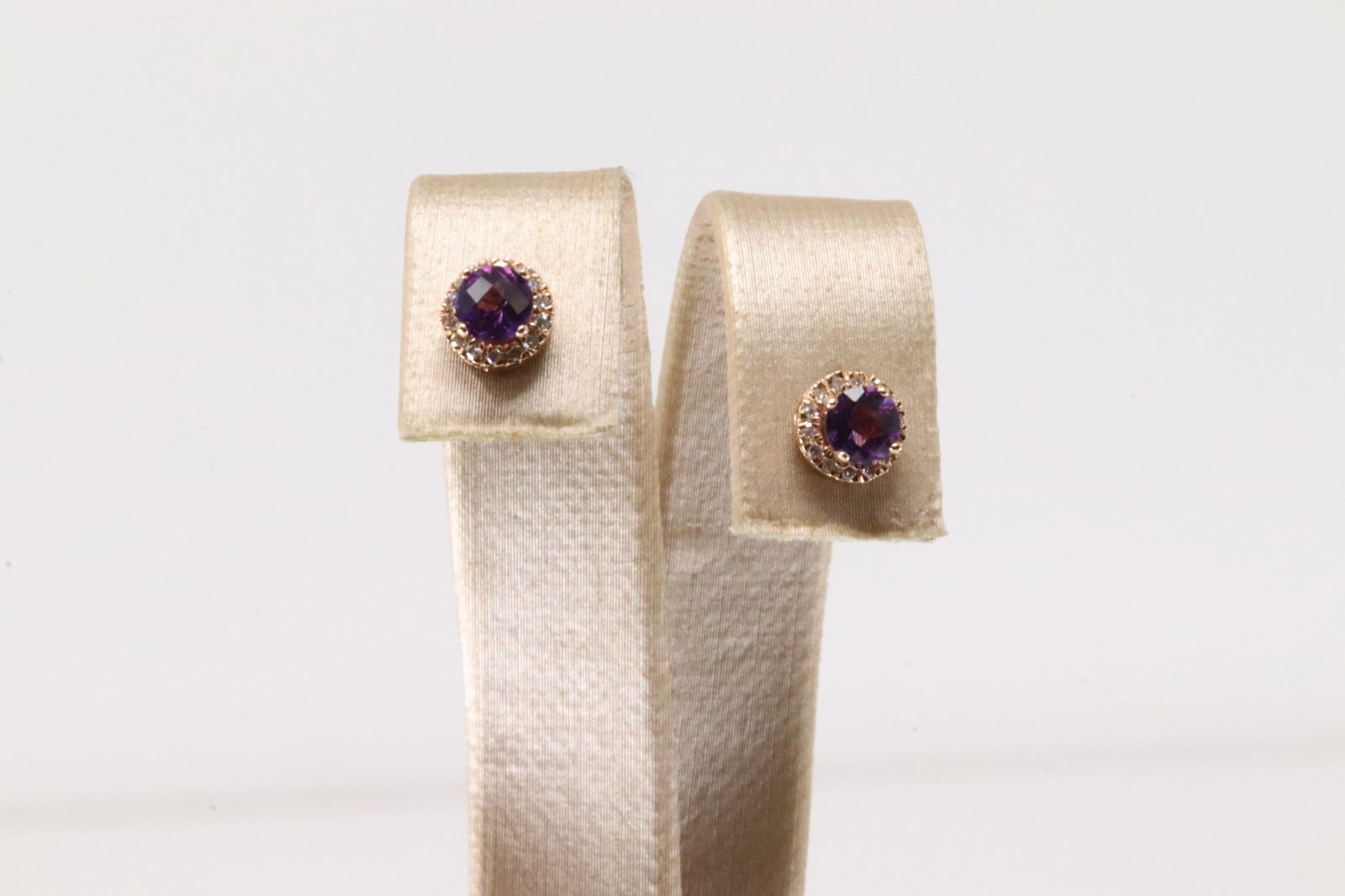 Amethyst & Diamond Stud Earring 10Kt.: Ladies 10Kt Rose Gold Amethyst & Diamond Stud Earring. This Stud Earring's has Purple Amethyst with 28 round Diamonds. Diamonds weight: 0.09ctw. Amethyst weight: 0.48ctw.