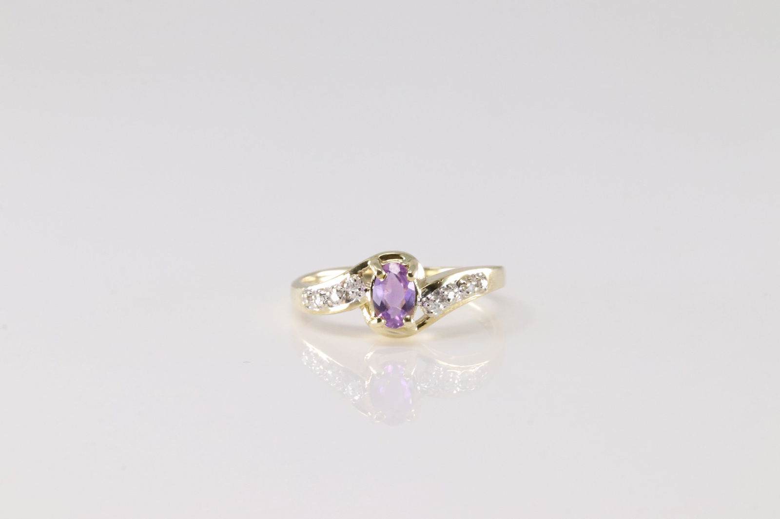 Amethyst & Diamond Ring 14Kt.: Ladies 14Kt Yellow Gold Amethyst & Diamond Ring. This Charming Ring has Purple Amethyst with Sparkling Diamonds. Ring size: 6.50. Total weight: 2.50 Grams.
