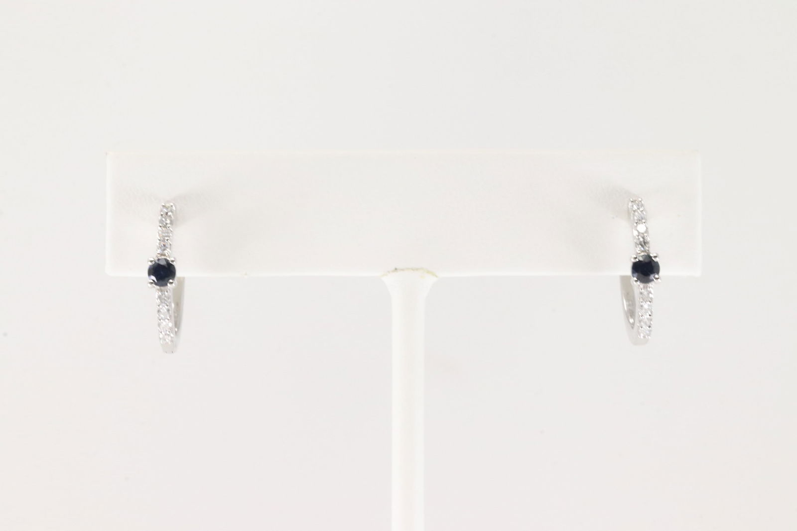 Sapphire & Diamond Hoop Earring 14Kt.: Ladies 14Kt White Gold Sapphire & Diamond Hoop Earring. This Earring's have 16 Round Sparkling Diamonds & Beautiful Blue Sapphire Gemstones In The Middle. Diamond Weight: 0.25ct. Sapphire Weight: