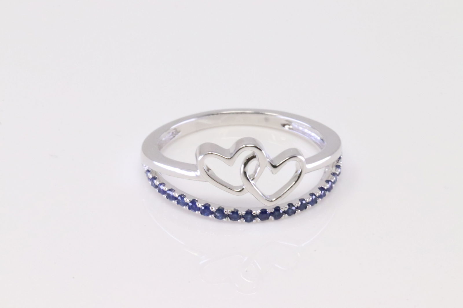 Sapphire Heart Ring 10Kt.: Ladies 10Kt White Gold Sapphire Heart Ring. Ring has 20 round Blue Sapphire with 2 Heart's Ring size: 7.00. Total weight: 2.20 Grams.