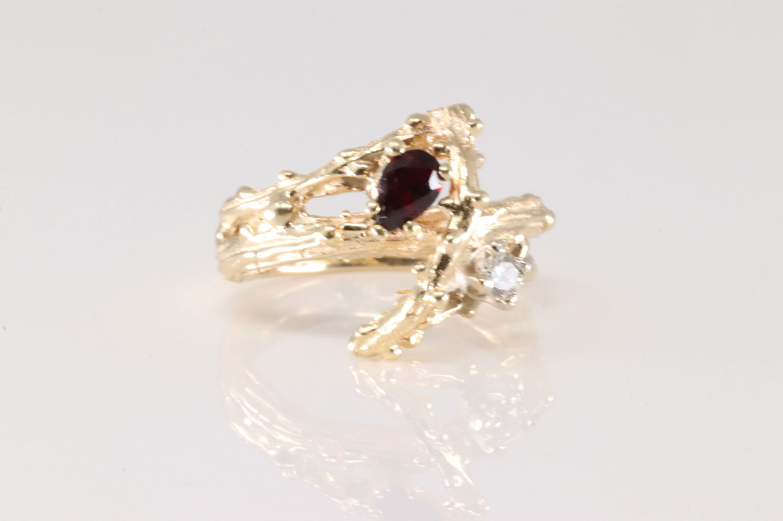 Garnet & Diamond Ring 14Kt.: Ladies 14Kt Yellow Gold Garnet & Diamond Ring. Ring has a design with tear-drop garnet with one round sparkling diamond. Ring size: 4.50. Total weight: 4.60 Grams.