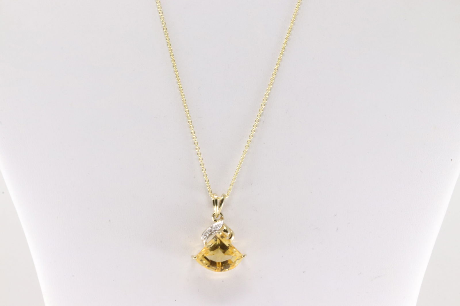 Citrine and Diamond Pendant / Necklace 10Kt.: 10Kt Yellow Gold Citrine and Diamond Pendant / Necklace. This pendant has cut triangle-shape citrine with round diamonds and a 14k Necklace. Necklace length: 18.00" Total weight: 4.60 Grams.