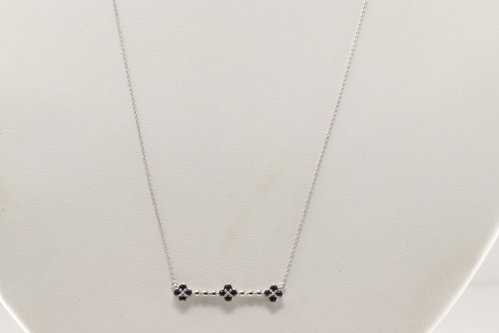 Sapphire Necklace 10Kt.: Ladies 10Kt White Gold Sapphire Necklace. This Necklace has a Charm Flowers Design with Blue Sapphires. Necklace length: 18.00"